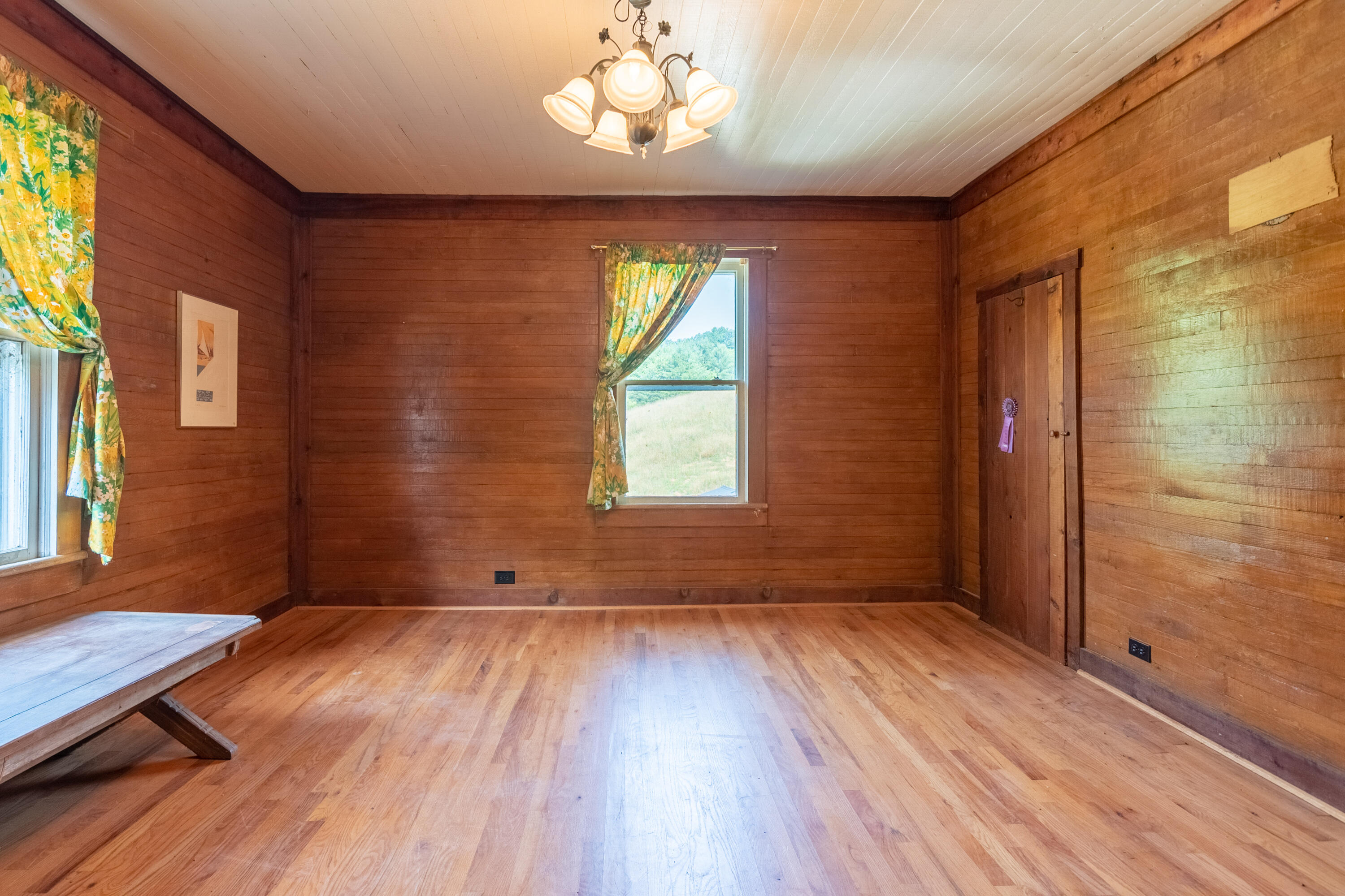 415 Reed Hill Road Northwest Floyd, VA 24091 - Photo 44 of 69 an empty room with wooden floor and windows