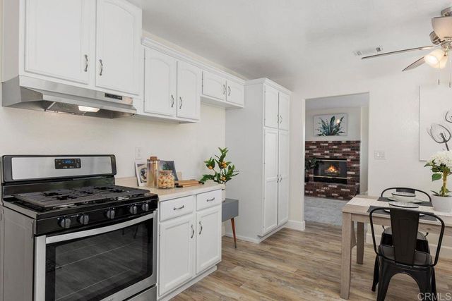 a view of a dining room with furniture wooden floor and a chandelier
