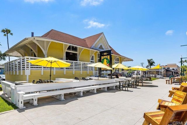 a view of sign board with potted plants