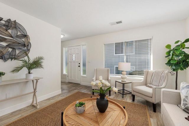 a living room with furniture and a potted plant