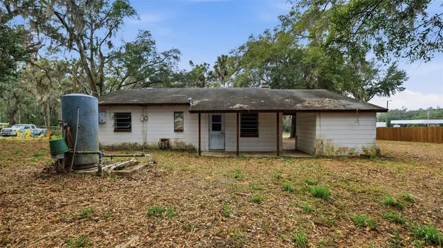 a view of backyard with small cabin and a chair