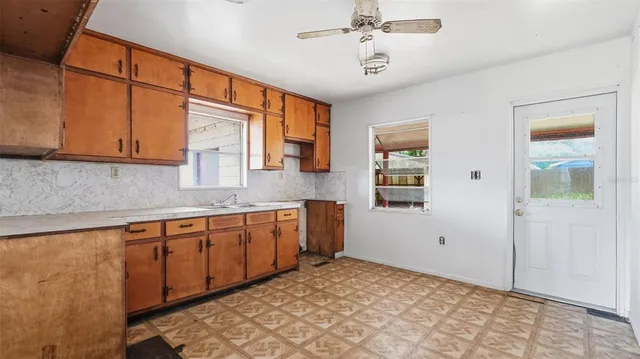 a view of a kitchen with kitchen island granite countertop cabinets and wooden floor