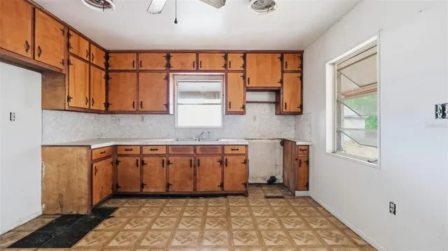 a kitchen with stainless steel appliances granite countertop a sink stove and cabinets