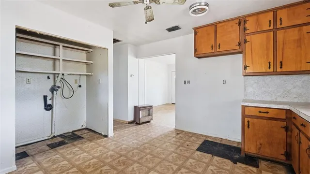 a view of a small space with wooden floor and a window