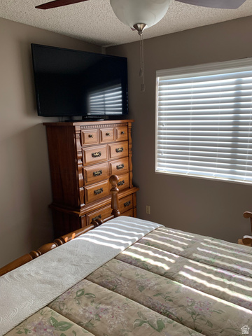 220 West Mill Road Ferron, UT 84523 - Photo 22 of 40 Room featuring a ceiling fan with integrated lighting, window with horizontal blinds, and neutral wall color