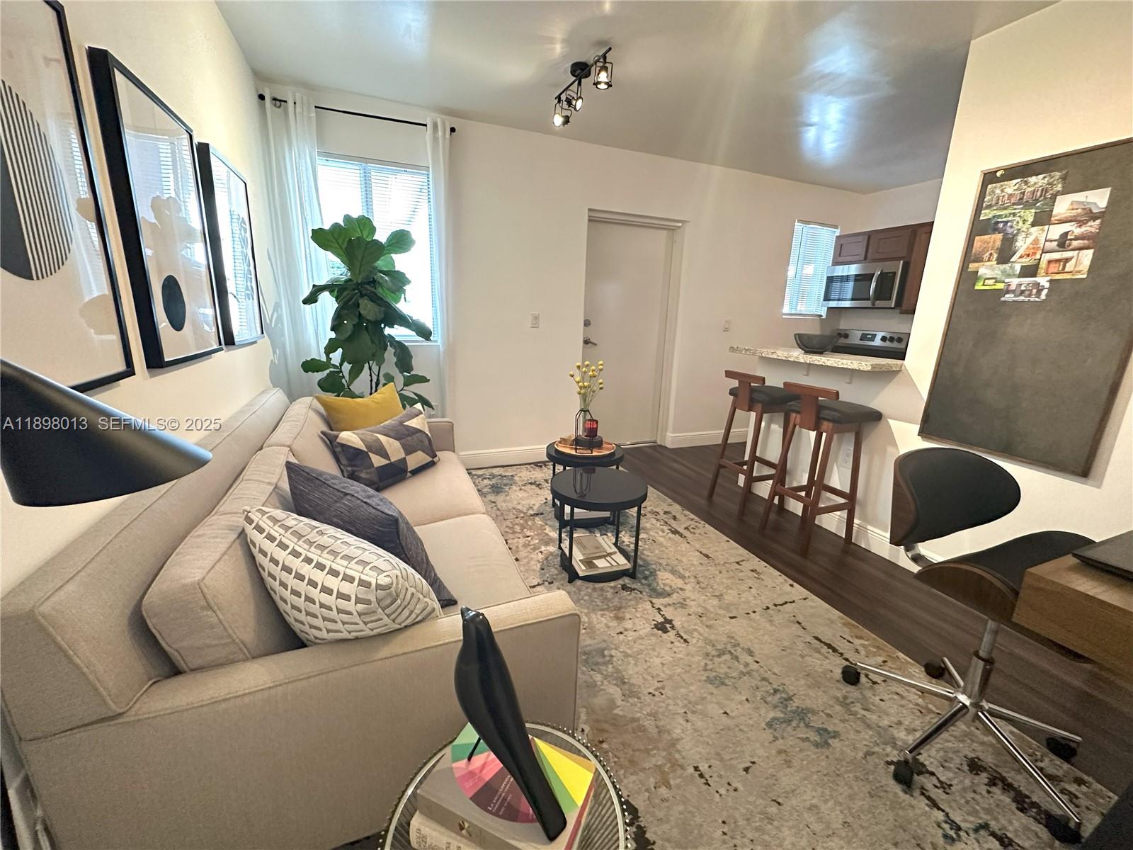 540 Northwest 7th Street, Unit 26 Miami, FL 33136 - Photo 2 of 7 a living room with furniture and a flat screen tv