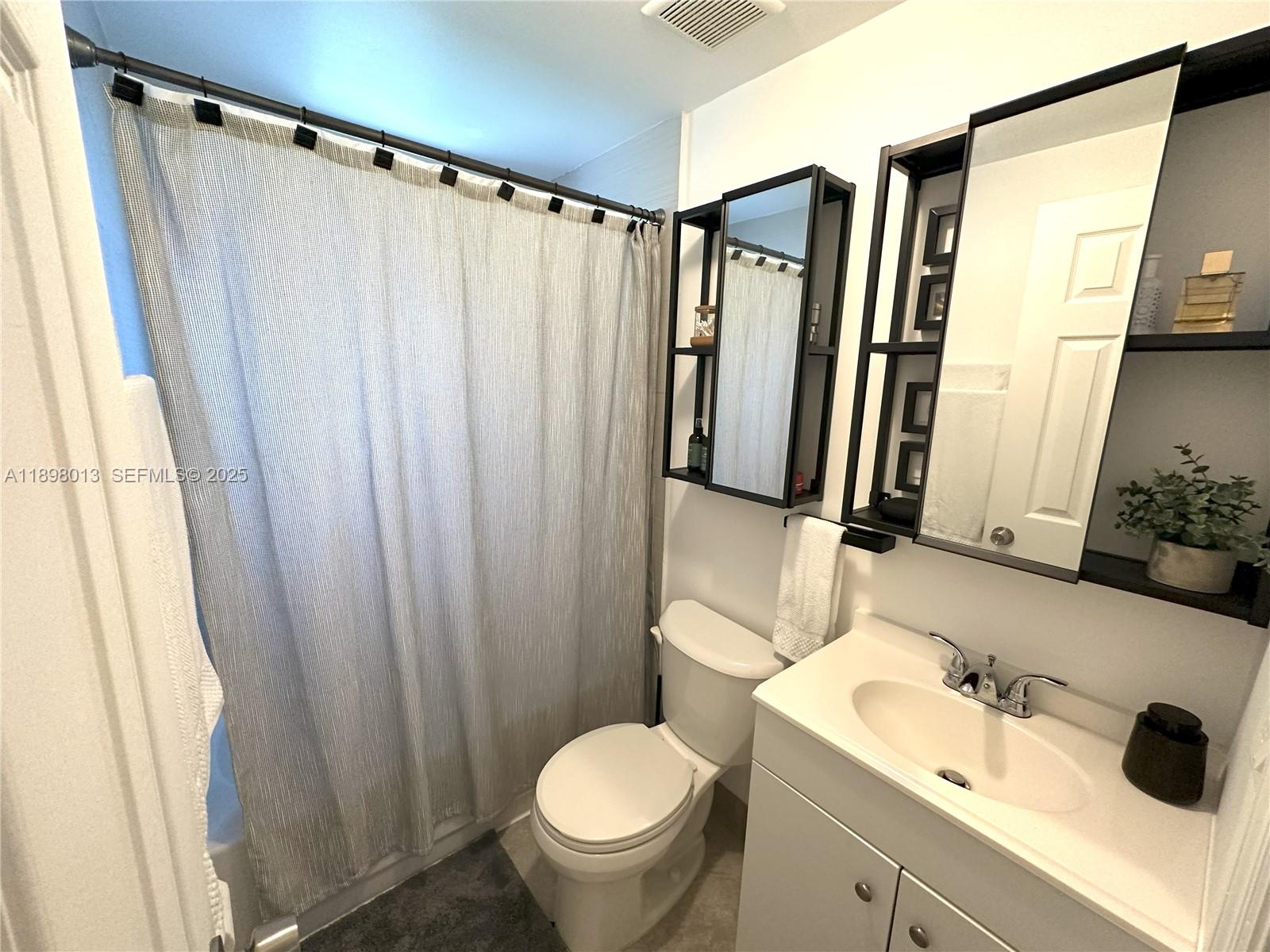 540 Northwest 7th Street, Unit 26 Miami, FL 33136 - Photo 6 of 7 a bathroom with a sink and a mirror
