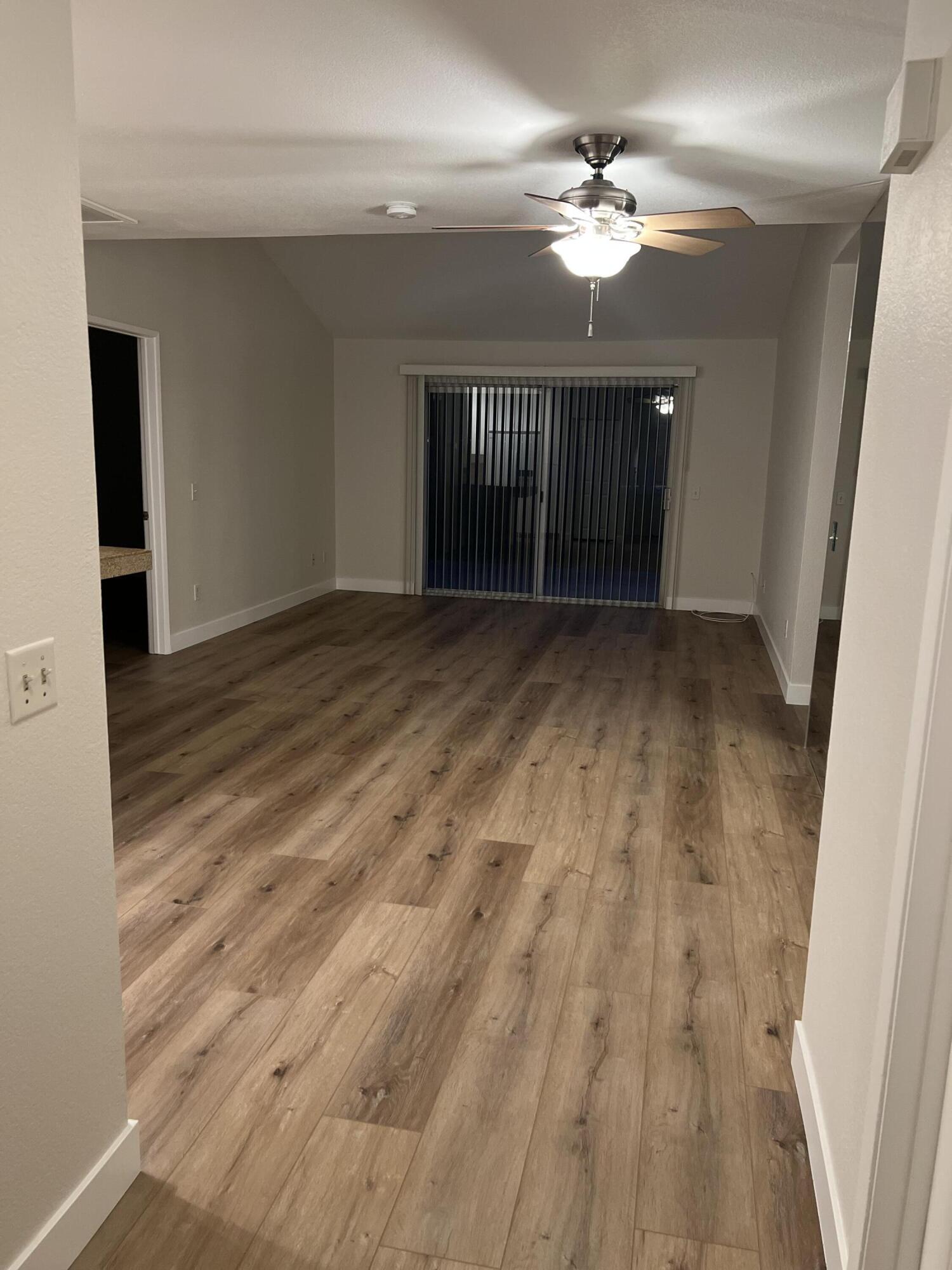 79307 South Sunset Ridge Drive La Quinta, CA 92253 - Photo 11 of 32 wooden floor in an empty room with a window