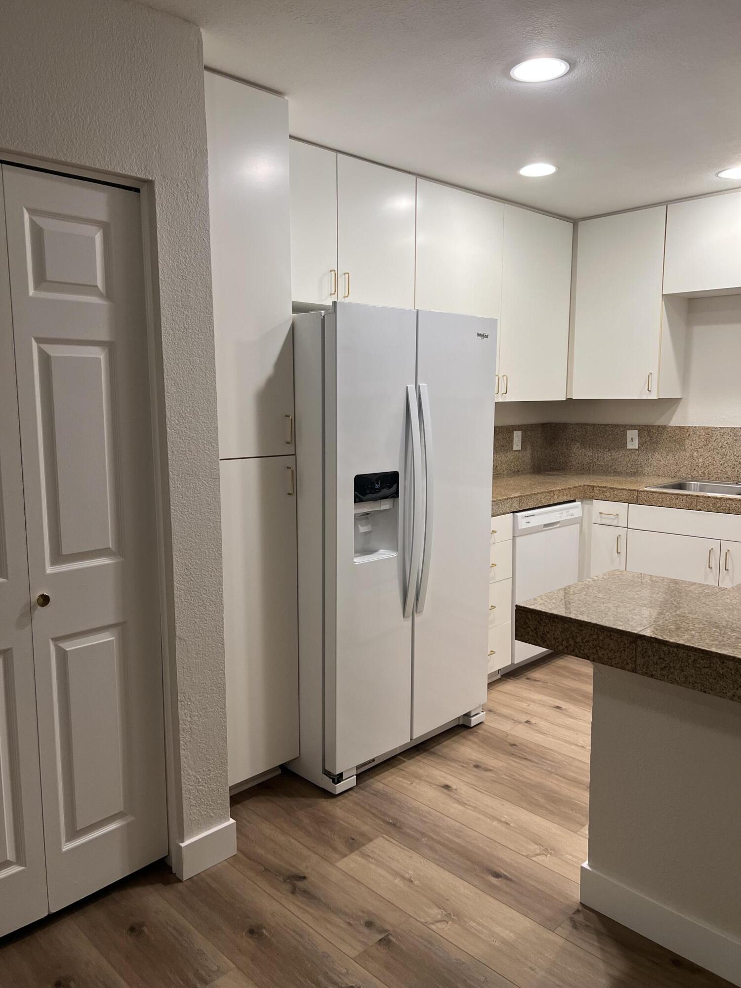 79307 South Sunset Ridge Drive La Quinta, CA 92253 - Photo 12 of 32 a kitchen with stainless steel appliances a refrigerator and a sink