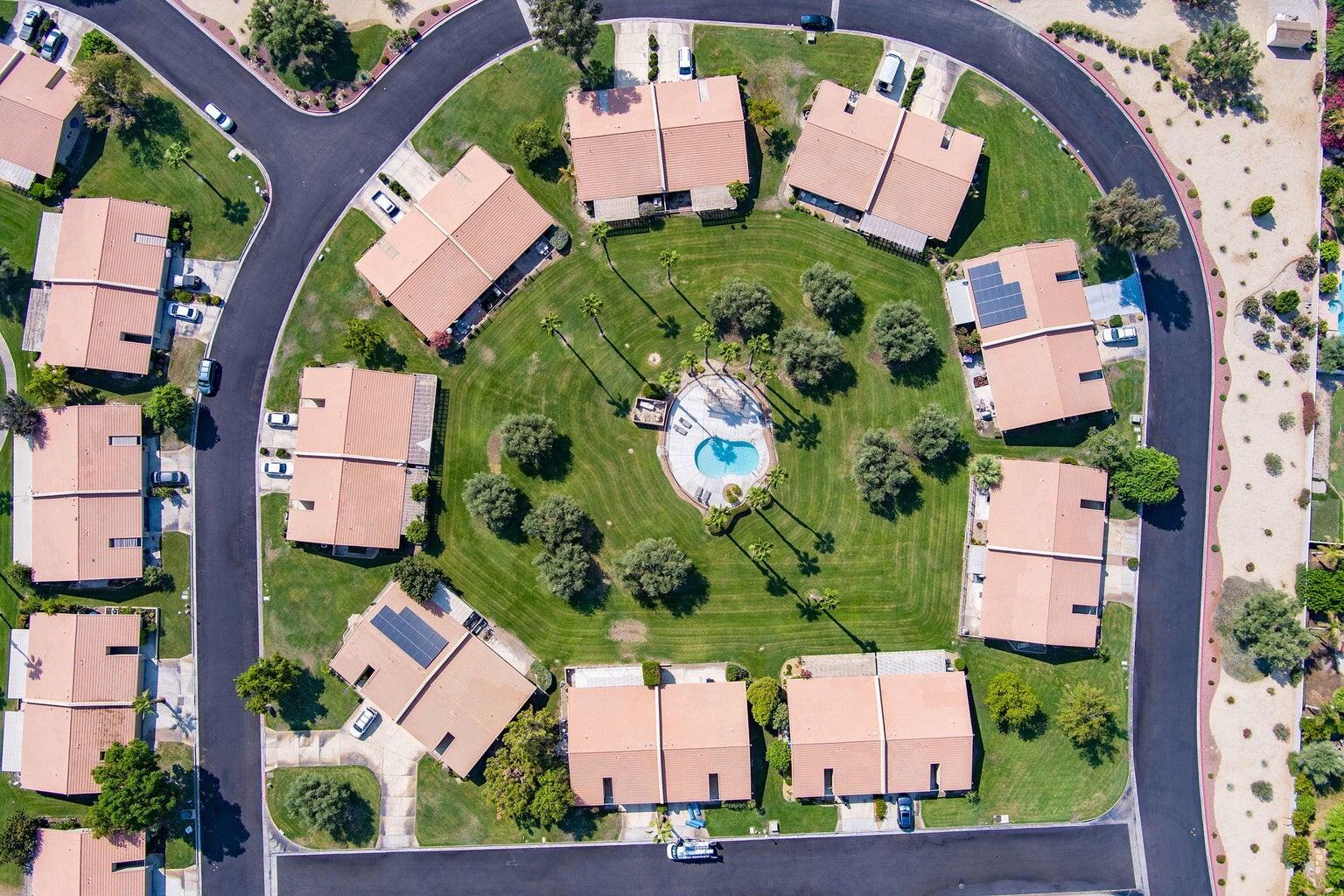 79307 South Sunset Ridge Drive La Quinta, CA 92253 - Photo 2 of 32 an aerial view of a house with a yard and green space