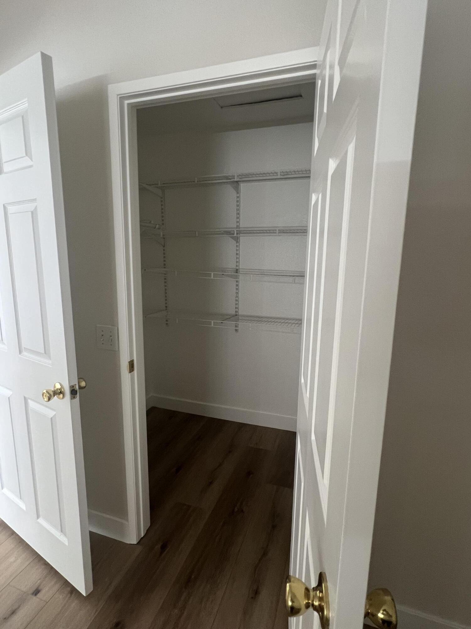 79307 South Sunset Ridge Drive La Quinta, CA 92253 - Photo 25 of 32 an empty room with wooden floor and closet