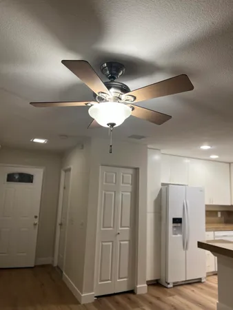 a kitchen with stainless steel appliances granite countertop a sink a refrigerator and a granite counter tops