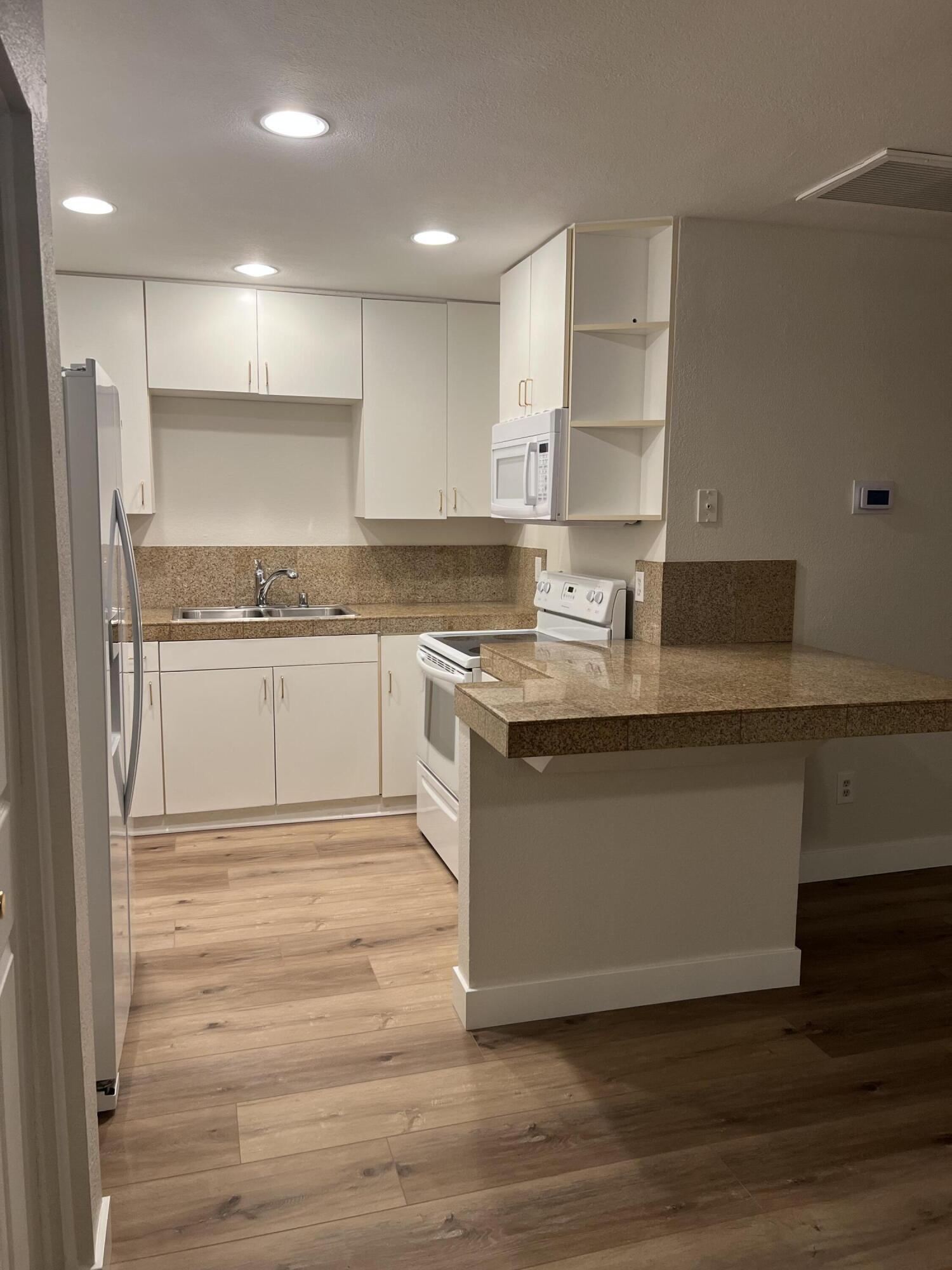79307 South Sunset Ridge Drive La Quinta, CA 92253 - Photo 9 of 32 a kitchen with stainless steel appliances granite countertop a stove a sink and a refrigerator