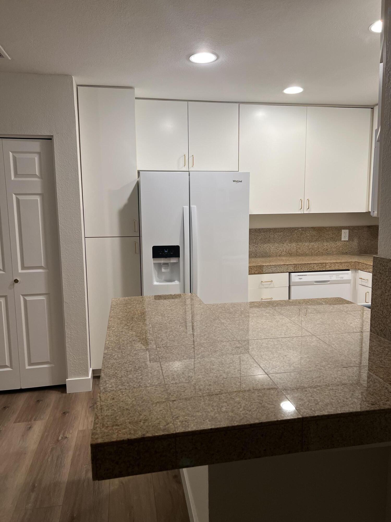 79307 South Sunset Ridge Drive La Quinta, CA 92253 - Photo 10 of 32 a view of a refrigerator in kitchen and wooden floor