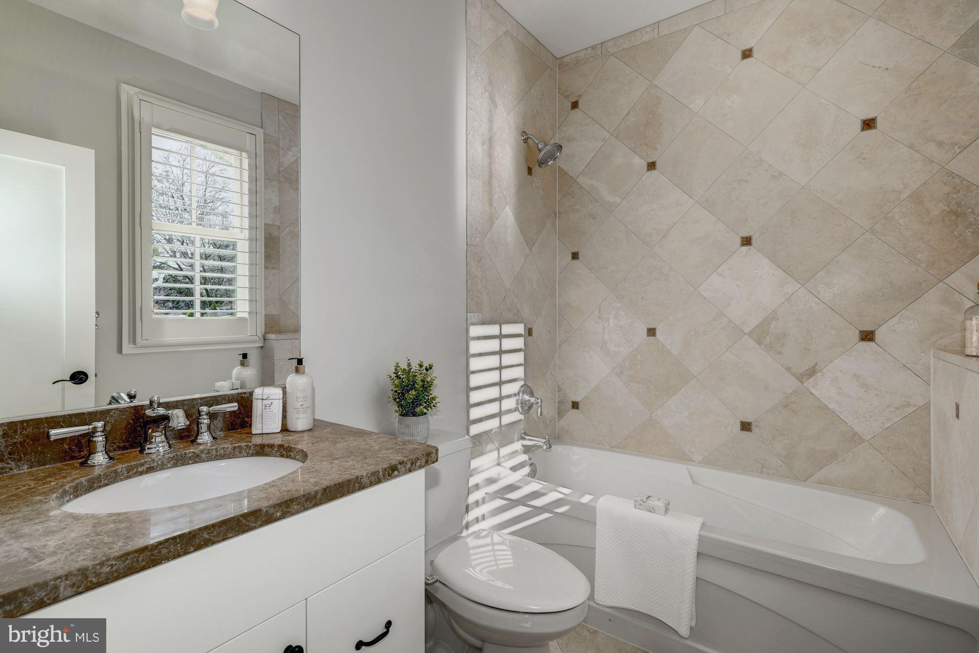 3007 North Rochester Street Arlington, VA 22213 - Photo 27 of 43 a bathroom with a granite countertop sink mirror vanity and toilet