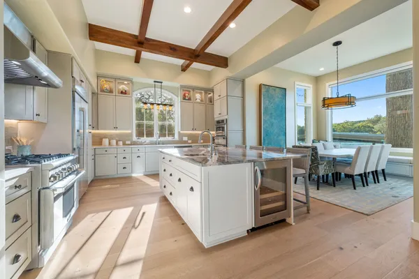 a bathroom with a granite countertop sink two mirror and a bathtub