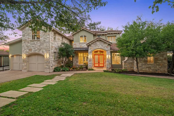 a kitchen with stainless steel appliances white cabinets and wooden floors