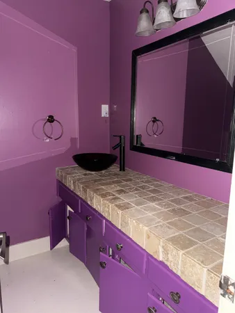 a bathroom with a sink a mirror and a shower