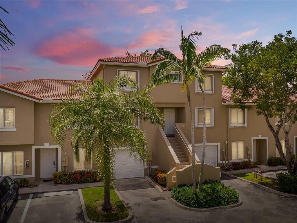 217 Riviera Circle, Unit 217 Weston, FL 33326 - Photo 1 of 58 a front view of a house with garden