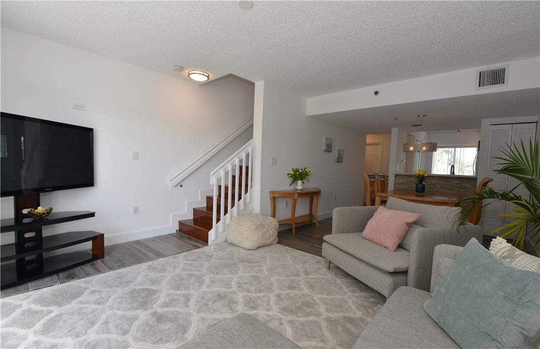 217 Riviera Circle, Unit 217 Weston, FL 33326 - Photo 11 of 58 a living room with furniture and a flat screen tv
