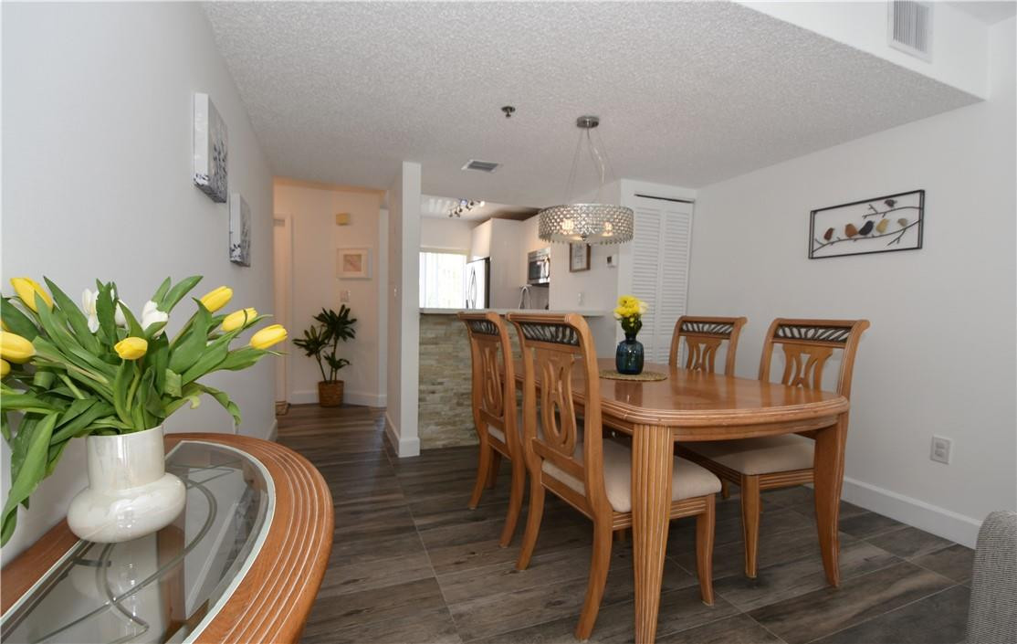217 Riviera Circle, Unit 217 Weston, FL 33326 - Photo 15 of 58 a view of a dining room with furniture and wooden floor