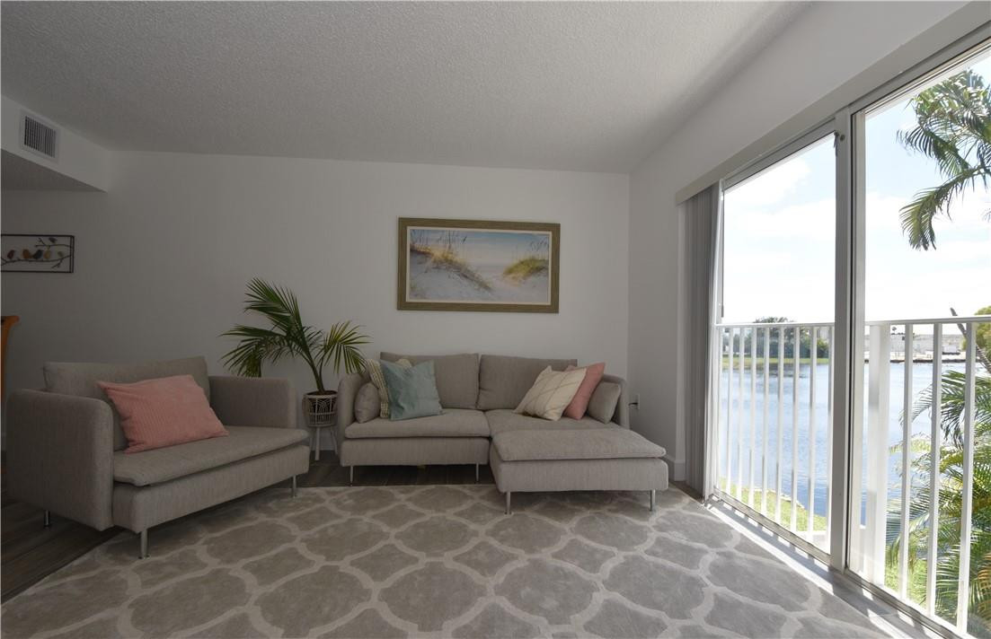 217 Riviera Circle, Unit 217 Weston, FL 33326 - Photo 18 of 58 a living room with furniture and a large window