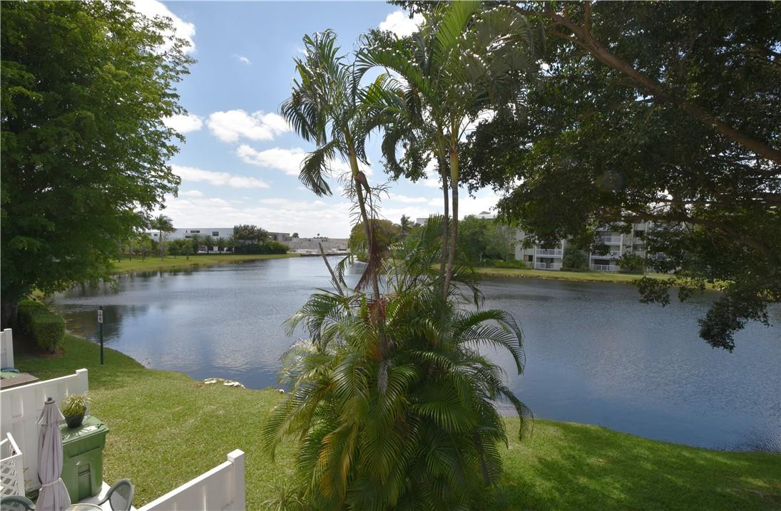 217 Riviera Circle, Unit 217 Weston, FL 33326 - Photo 19 of 58 a view of a lake from a yard