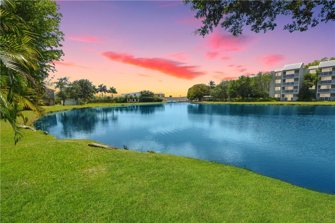217 Riviera Circle, Unit 217 Weston, FL 33326 - Photo 2 of 58 a view of a lake with houses in the background