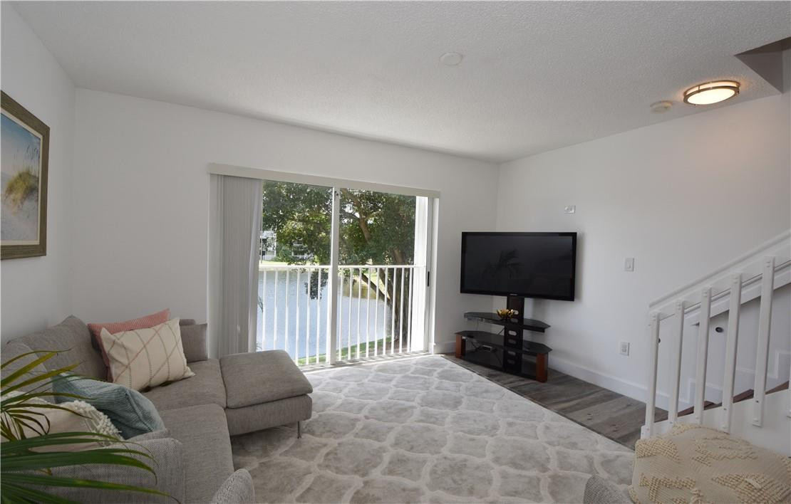 217 Riviera Circle, Unit 217 Weston, FL 33326 - Photo 21 of 58 a living room with furniture and a flat screen tv