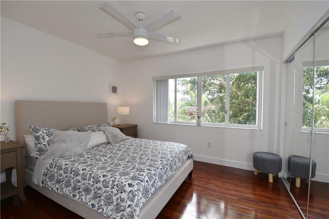 217 Riviera Circle, Unit 217 Weston, FL 33326 - Photo 24 of 58 a bedroom with a bed chairs and a window