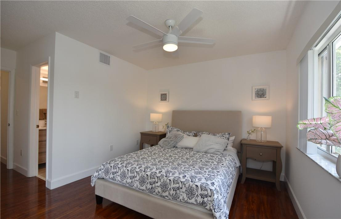 217 Riviera Circle, Unit 217 Weston, FL 33326 - Photo 25 of 58 a bedroom with a bed and a window