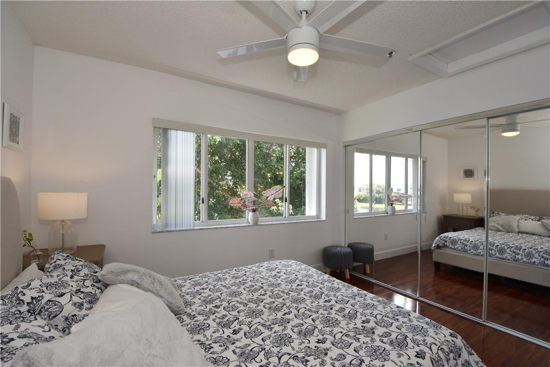 217 Riviera Circle, Unit 217 Weston, FL 33326 - Photo 27 of 58 a bedroom with a bed and a window