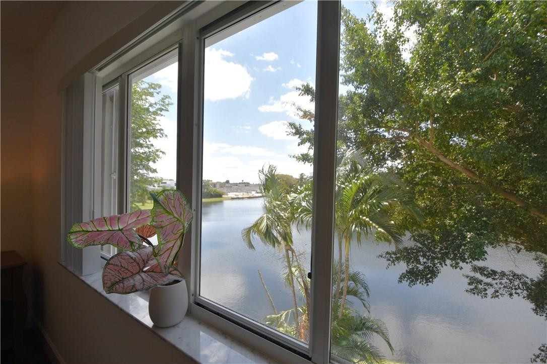 217 Riviera Circle, Unit 217 Weston, FL 33326 - Photo 28 of 58 a view of a balcony with floor to ceiling windows with wooden floor