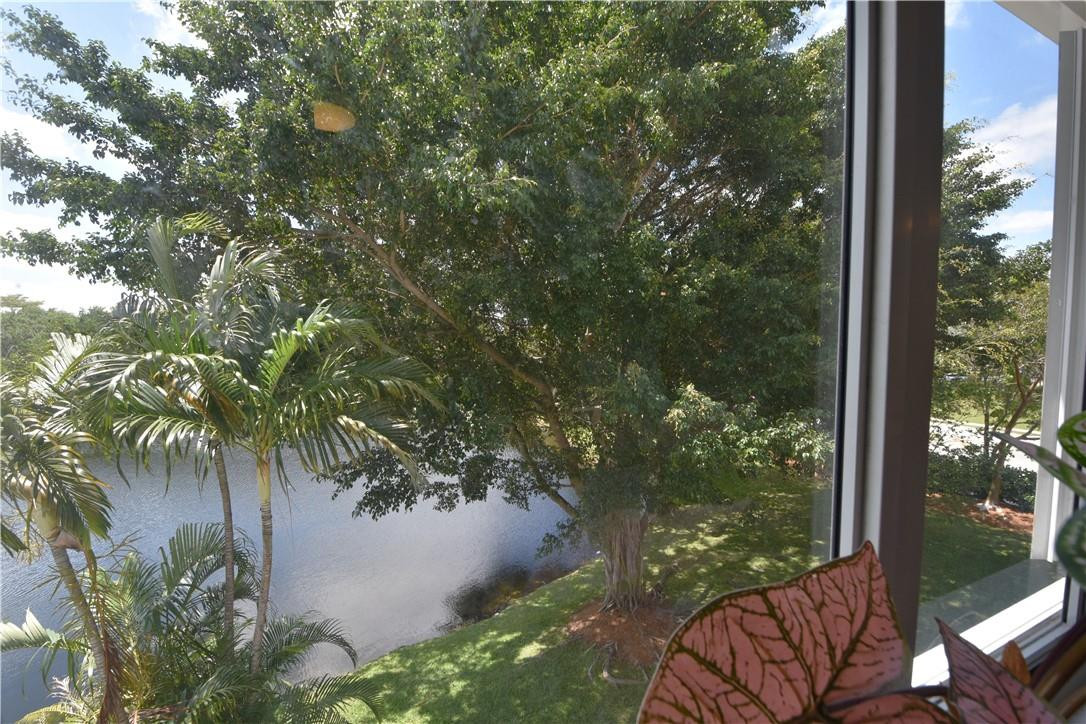 217 Riviera Circle, Unit 217 Weston, FL 33326 - Photo 29 of 58 a view of a yard from a balcony