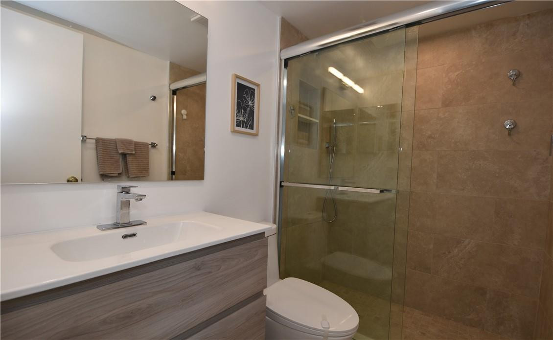 217 Riviera Circle, Unit 217 Weston, FL 33326 - Photo 30 of 58 a bathroom with a sink shower and a toilet