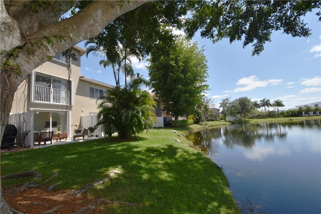 217 Riviera Circle, Unit 217 Weston, FL 33326 - Photo 3 of 58 a view of a lake with houses