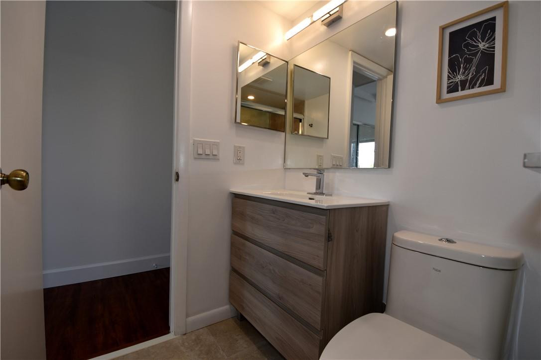 217 Riviera Circle, Unit 217 Weston, FL 33326 - Photo 31 of 58 a bathroom with a toilet sink and mirror