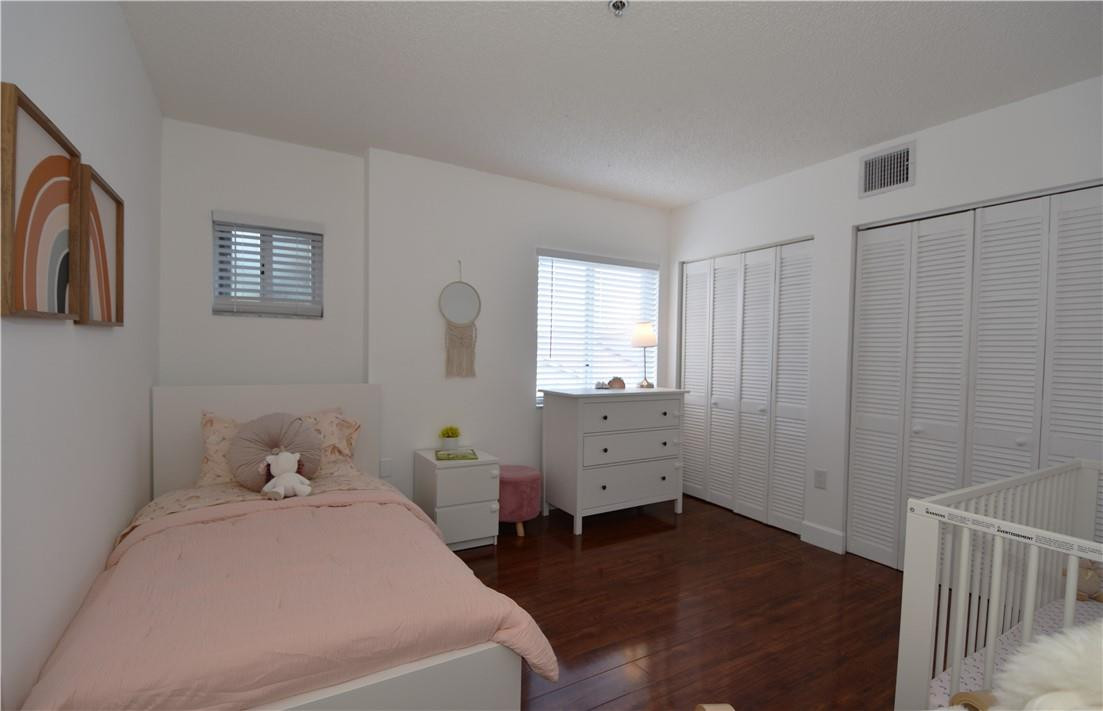 217 Riviera Circle, Unit 217 Weston, FL 33326 - Photo 33 of 58 a bedroom with a bed and a window