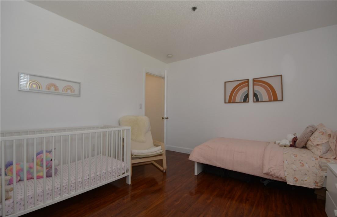 217 Riviera Circle, Unit 217 Weston, FL 33326 - Photo 34 of 58 a bedroom with a bed and a painting on the wall