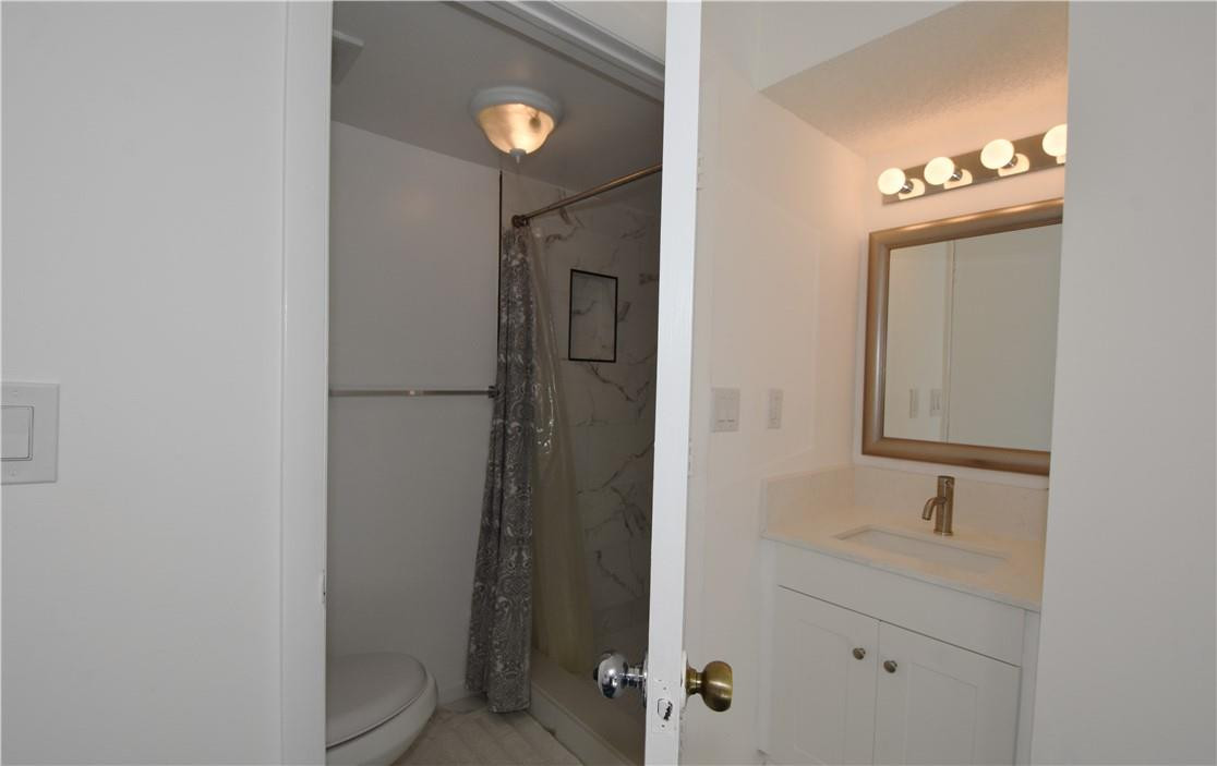 217 Riviera Circle, Unit 217 Weston, FL 33326 - Photo 42 of 58 a bathroom with a shower a sink and a mirror