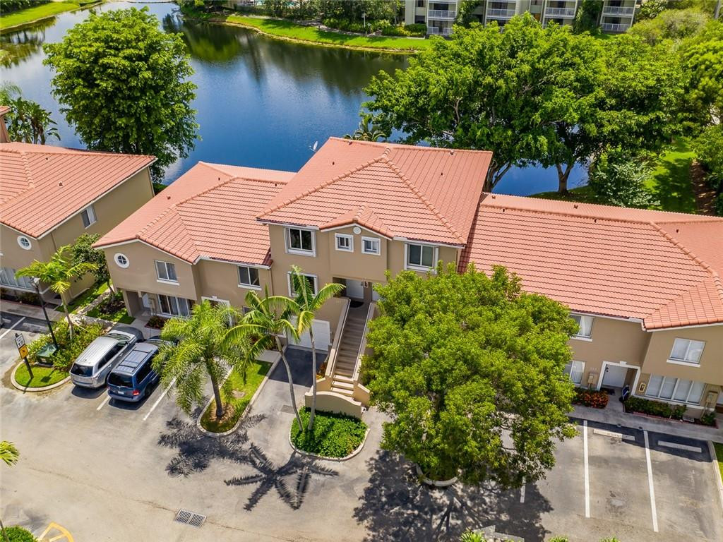 217 Riviera Circle, Unit 217 Weston, FL 33326 - Photo 5 of 58 a backyard of a house with chairs