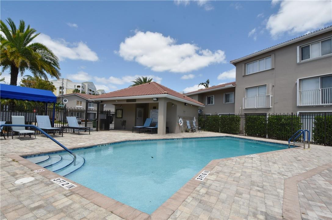 217 Riviera Circle, Unit 217 Weston, FL 33326 - Photo 54 of 58 a view of a house with sitting area and swimming pool