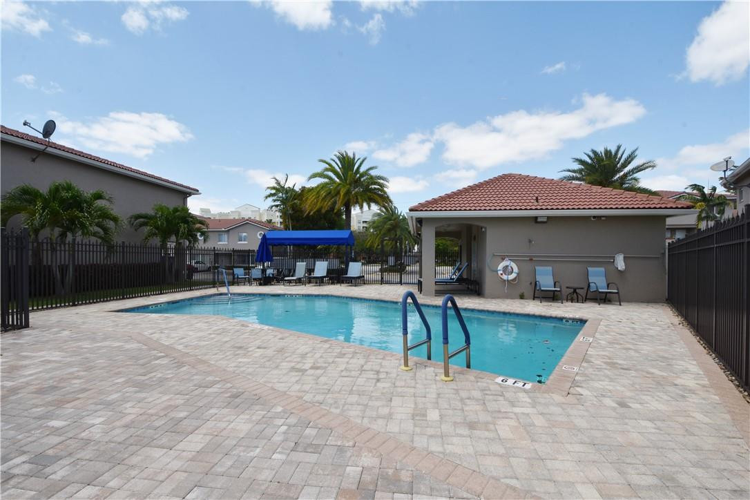 217 Riviera Circle, Unit 217 Weston, FL 33326 - Photo 55 of 58 a view of a house with swimming pool and sitting area