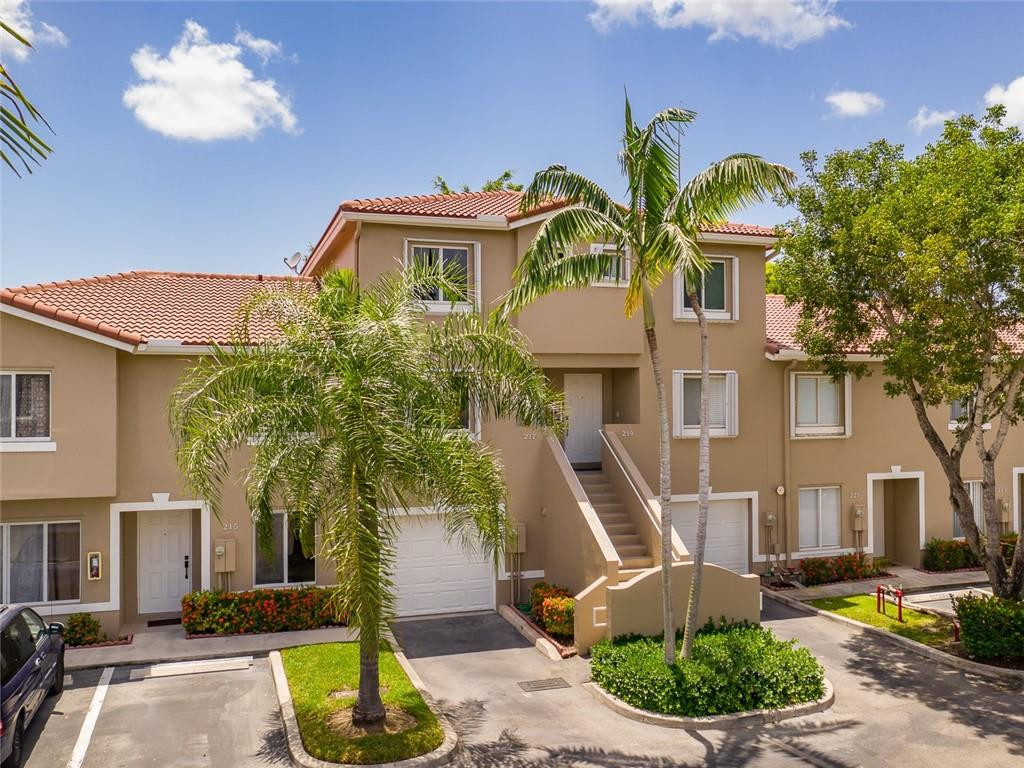 217 Riviera Circle, Unit 217 Weston, FL 33326 - Photo 57 of 58 a front view of house with yard and green space