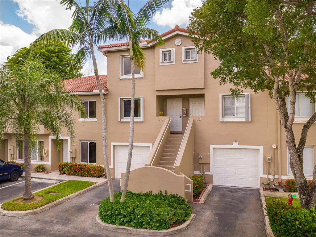 217 Riviera Circle, Unit 217 Weston, FL 33326 - Photo 7 of 58 a front view of a house with garden