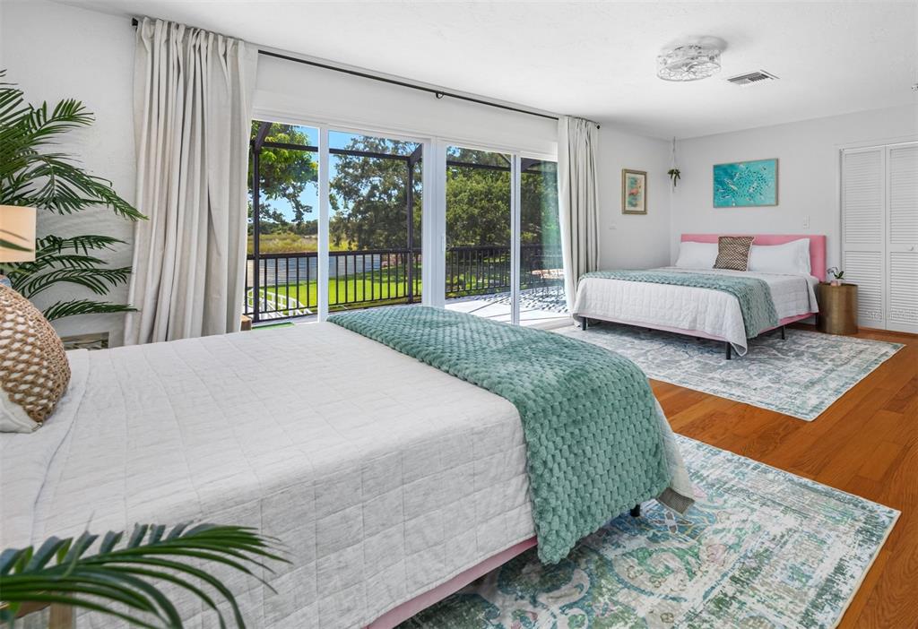 2153 Karan Way Clearwater, FL 33763 - Photo 30 of 65 a bedroom with a bed lamp and a large window