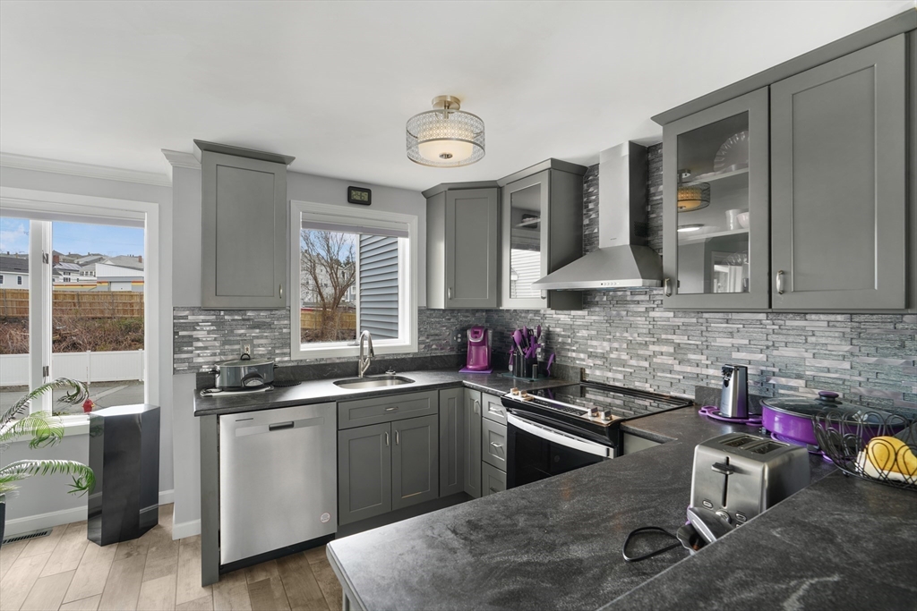 700 Shore Drive, Unit 813 Fall River, MA 02721 - Photo 6 of 29 a kitchen with a sink stove and cabinets