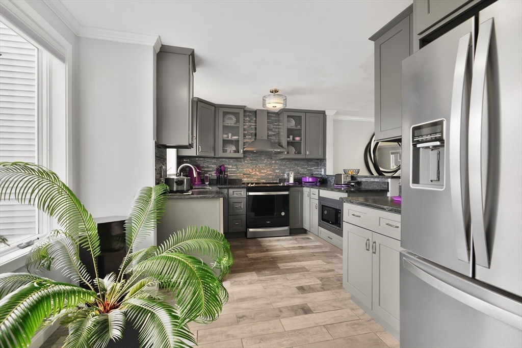 700 Shore Drive, Unit 813 Fall River, MA 02721 - Photo 7 of 29 a kitchen with stainless steel appliances a stove a sink and a refrigerator