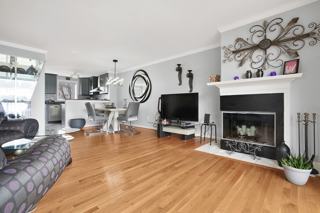 700 Shore Drive, Unit 813 Fall River, MA 02721 - Photo 9 of 29 a living room with furniture a flat screen tv and a fireplace