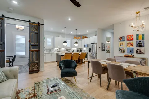 a living room with furniture kitchen view and a refrigerator